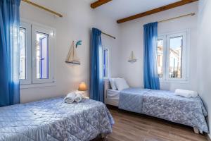 Posteľ alebo postele v izbe v ubytovaní SUN NEST HOUSE
