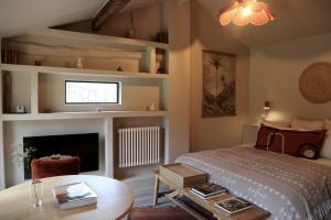 a bedroom with a bed and a table and a tv at CASAMAAS in Les Basses Masures
