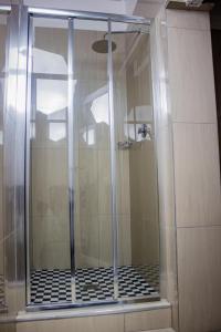a shower with a glass door in a bathroom at 18 on sherlock in Port Elizabeth
