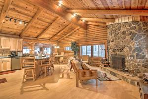 a kitchen and living room with a stone fireplace at 11 Mi to Rainbow Lake Family Home with Large Yard in Indian Pine