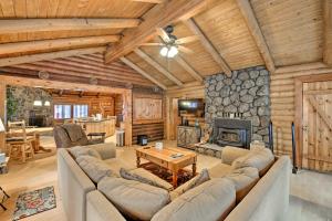 a living room with a couch and a fireplace at Pinetop Family Home 11 Miles to Rainbow Lake! in Indian Pine