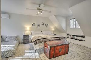 a bedroom with a bed and a ceiling fan at Cozy Cabin about 3 Mi to Lake Arrowhead Village! in Lake Arrowhead