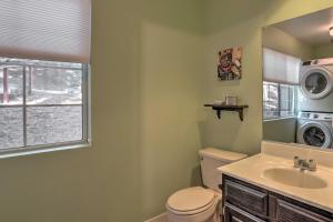 a bathroom with a toilet and a sink and a washing machine at Cozy Cabin about 3 Mi to Lake Arrowhead Village! in Lake Arrowhead +21 photos