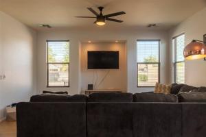 a living room with a couch and a ceiling fan at Gated house near South Mountain with pool heater, BBQ in Phoenix
