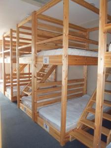 a group of bunk beds in a room at Natural Onsen Hostel Hidamari no Yu in Takayama