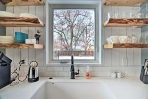 a kitchen counter with a sink and a window at Contemporary Longmont Hideaway in Old Town! in Longmont +23 photos