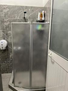 a stainless steel refrigerator in a bathroom with at Apartament Gjergji in Sarandë