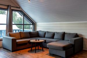 a living room with a couch and a table at Bakkebyvegen 22B in Trysil