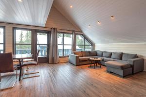 a living room with a couch and a table at Bakkebyvegen 22B in Trysil