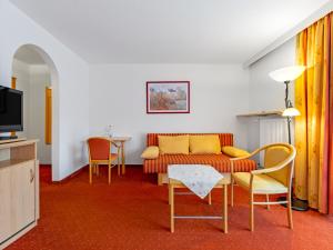 a living room with a couch and chairs at Landhotel Gabriele in Unterwössen