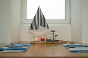 a wooden table with a sail boat on top of it at Villa Mar - Maia in Maia
