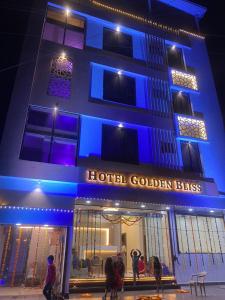 un bâtiment d'hôtel avec des lumières bleues devant lui dans l'établissement Hotel Golden Bliss, à Bhopal