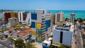 a city with a building with a mural on it at ibis budget Maceió Pajuçara in Maceió