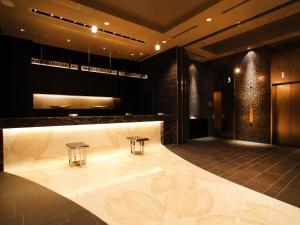 a bathroom with a bath tub with two stools at Hotel Monterey Hanzomon in Tokyo