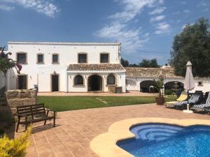 a large white house with a swimming pool in the yard at Villa Finca Sol Javea in Jávea