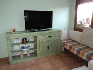 a tv on top of a cabinet in a living room at Cal Sabata in Estany