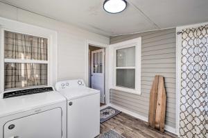 a kitchen with a washer and dryer next to a door at Modern Florence Getaway with Patio and Grill! in Florence +31 photos