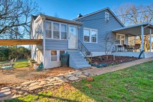 a blue house with a porch and a deck at Modern Florence Getaway with Patio and Grill! in Florence