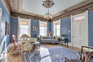 a living room with blue walls and a table and chairs at Charming Mt Pleasant Home in Historic Dtwn! in Spring City