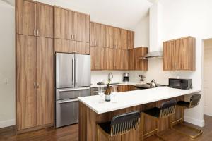 a kitchen with wooden cabinets and a refrigerator at 700 Monarch 301 in Aspen