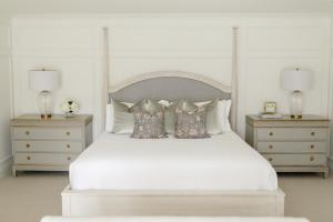 a bedroom with a white bed with two night stands at Fairville Inn in Chadds Ford