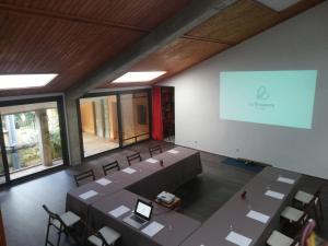 a conference room with tables and chairs and a screen at Main Villa: La Bruguera de Púbol in Púbol