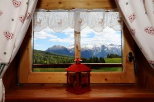a window with a view of mountains at Baita Medil in Predazzo