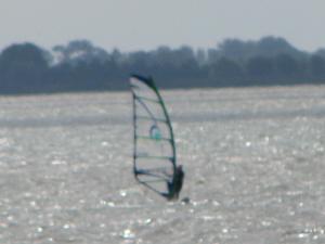 a person in the water with a wind sail at LES BERNACHES in Le Crotoy