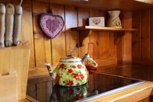 a tea kettle is sitting on a stove in a kitchen at Baita Medil in Predazzo