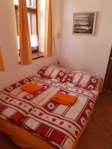 a bedroom with a bed with orange pillows at Ubytování U Dvořáků in Veselí nad Lužnicí