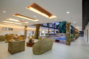 a lobby with chairs and a swimming pool at Marianne Hotel in Puerto Princesa City