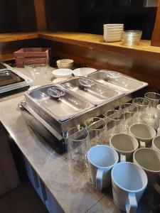 a counter with a bunch of glasses on it at Stettiner Hof in Eggesin +16 photos