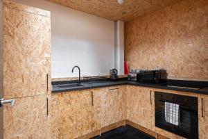 a kitchen with a sink and a stove top oven at CoalShed in Bristol