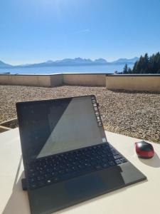 a laptop computer sitting on a table with a mouse at Apartment Wanderlust Gerlitzen in Kanzelhöhe