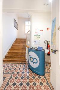 a hallway with a staircase with a blue trash can at TOP Coimbra in Coimbra