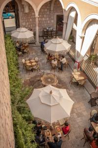 an overhead view of a patio with tables and umbrellas at Casa Vieja Hotel Boutique in Morelia