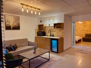 a living room with a couch and a table at Ran suites in Mas'ada