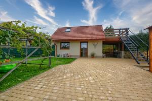 a house with a red roof and a staircase at Bieszczadzki Jeleń in Ustrzyki Dolne
