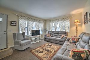 a living room with a couch and a tv at Cozy Houghton Lake Heights Cottage with Private Yard in Houghton Lake