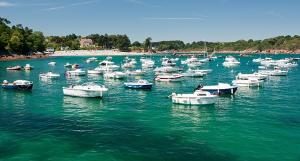 a group of boats in a large body of water at Maison bord de mer avec jacuzzi in Névez