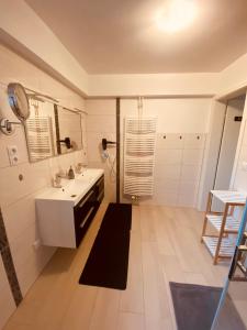 a bathroom with a sink and a mirror at Ferienwohnung Könnecke Bad Harzburg in Bad Harzburg