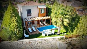 a house with a swimming pool and a villa at Villa Marlin in Kalkan