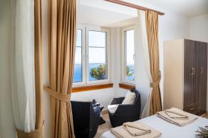 a hotel room with two beds and two windows at Villa Marlin in Kalkan +13 photos