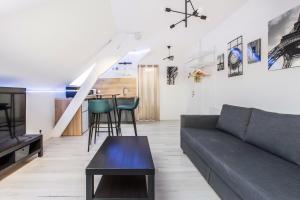 a living room with a couch and a table at Studio Paris in Tourcoing