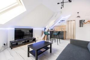 a living room with a couch and a table at Studio Paris in Tourcoing