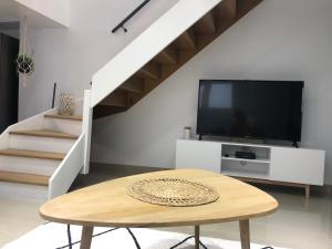 a living room with a table and a tv at Les Gouttes d'Or in Pierry