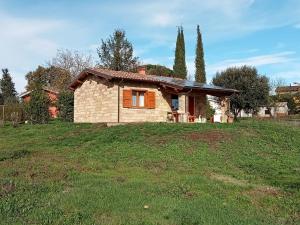 a small house on a grassy field at Serena Country home in Capranica