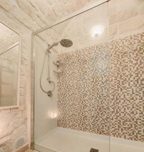 a bathroom with a shower with a glass door at Apartment Mammacara in Ceglie Messapica