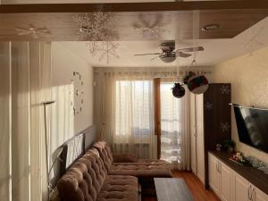 a living room with a couch and a tv at Apartment in Belvedere Holiday Club 550 m from ski lift in Bansko