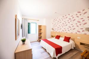 a bedroom with a large bed and a large window at Hotel Apartamentos Villa Gomera in San Sebastián de la Gomera